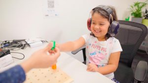 Child playing a game as part of Play Audiometry